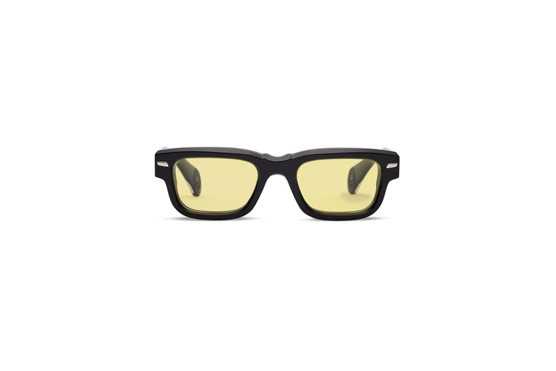 Sunglasses with yellow lenses and black frame on a white background
